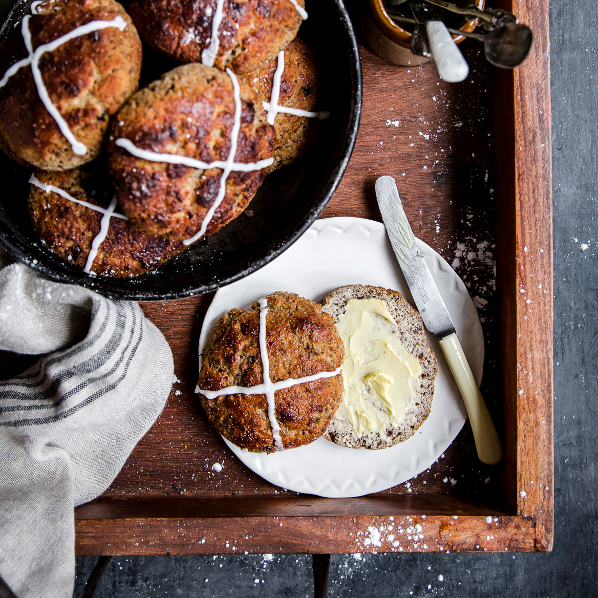 Baked Keto Yeast Hot Cross Buns served with butter.